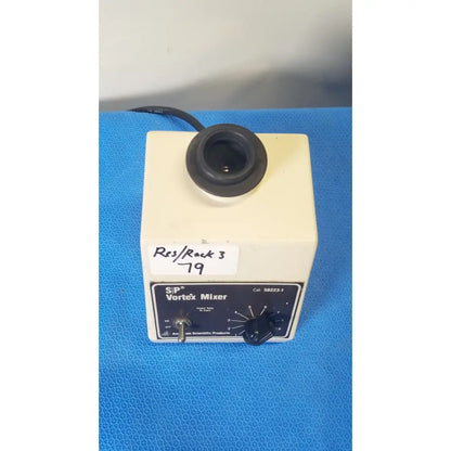 Cream-colored american scientific sp vortex mixer with black control panel knob and top lens for lab mixing tasks