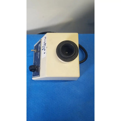Cream-colored scientific sp vortex mixer american scientific s8223-1 with black lens and blue control panel with knobs