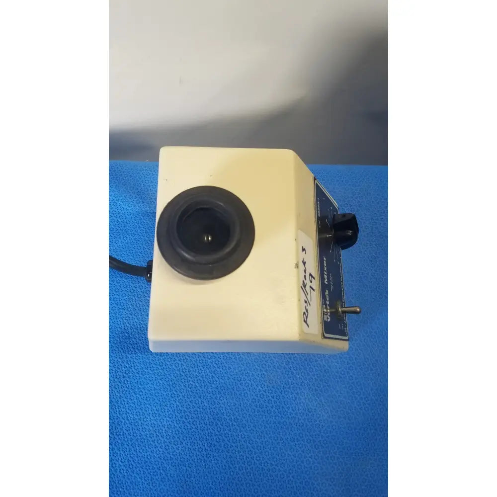 Cream-colored american scientific sp vortex mixer with rectangular design, black circular lens, knob, and control panel