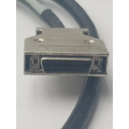 Silver-colored metal d-sub connector with black cable attached in amp scsi cable 26-pin vh dci to 26-pin male cable