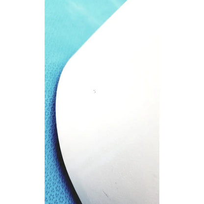 White curved smooth surface of ample scientific champion e33 centrifuge timer model resting on textured blue background