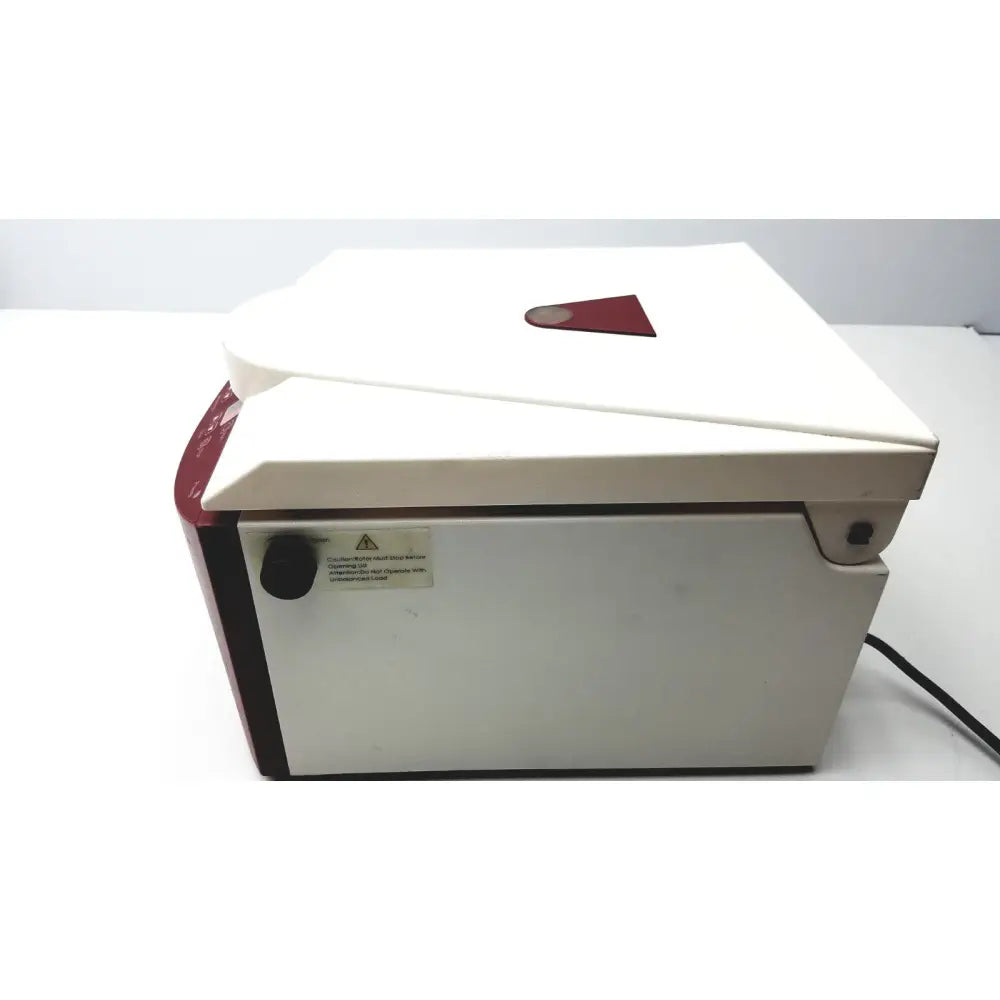 Ample scientific champion f-33d digital laboratory centrifuge in white and red with hinged lid and warning label on the side