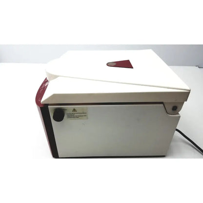 Ample scientific champion f-33d digital laboratory centrifuge in white and red with hinged lid and warning label on the side