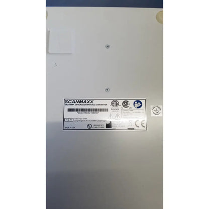 White Scanmaxx DS2165MP medical video converter with silver label, black text, and certification logos by Ampronix