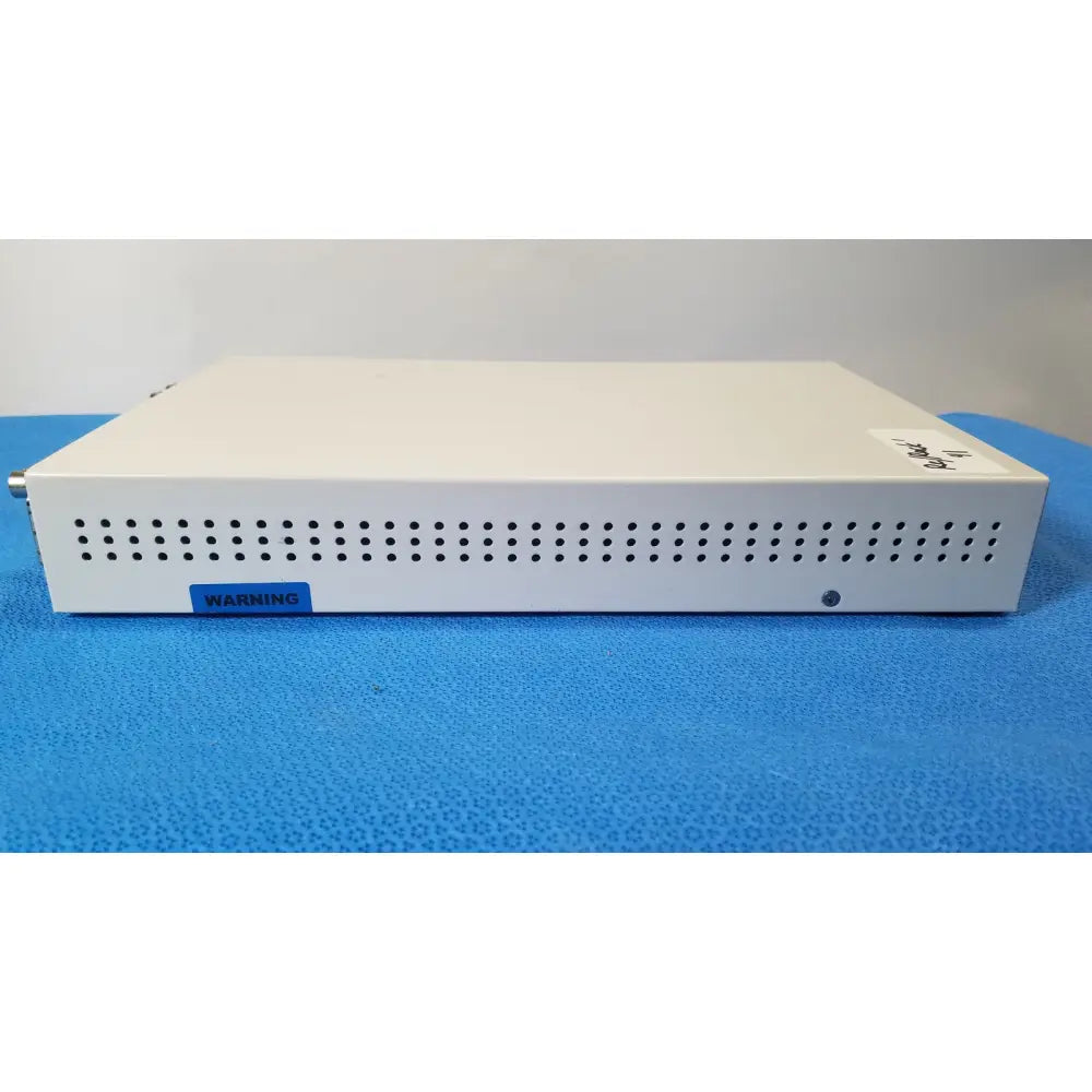 White rectangular electronic medical video converter with perforated front panel and blue warning label ampronix scanmaxx ds2165mp