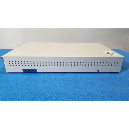 White rectangular electronic medical video converter with perforated front panel and blue warning label ampronix scanmaxx ds2165mp