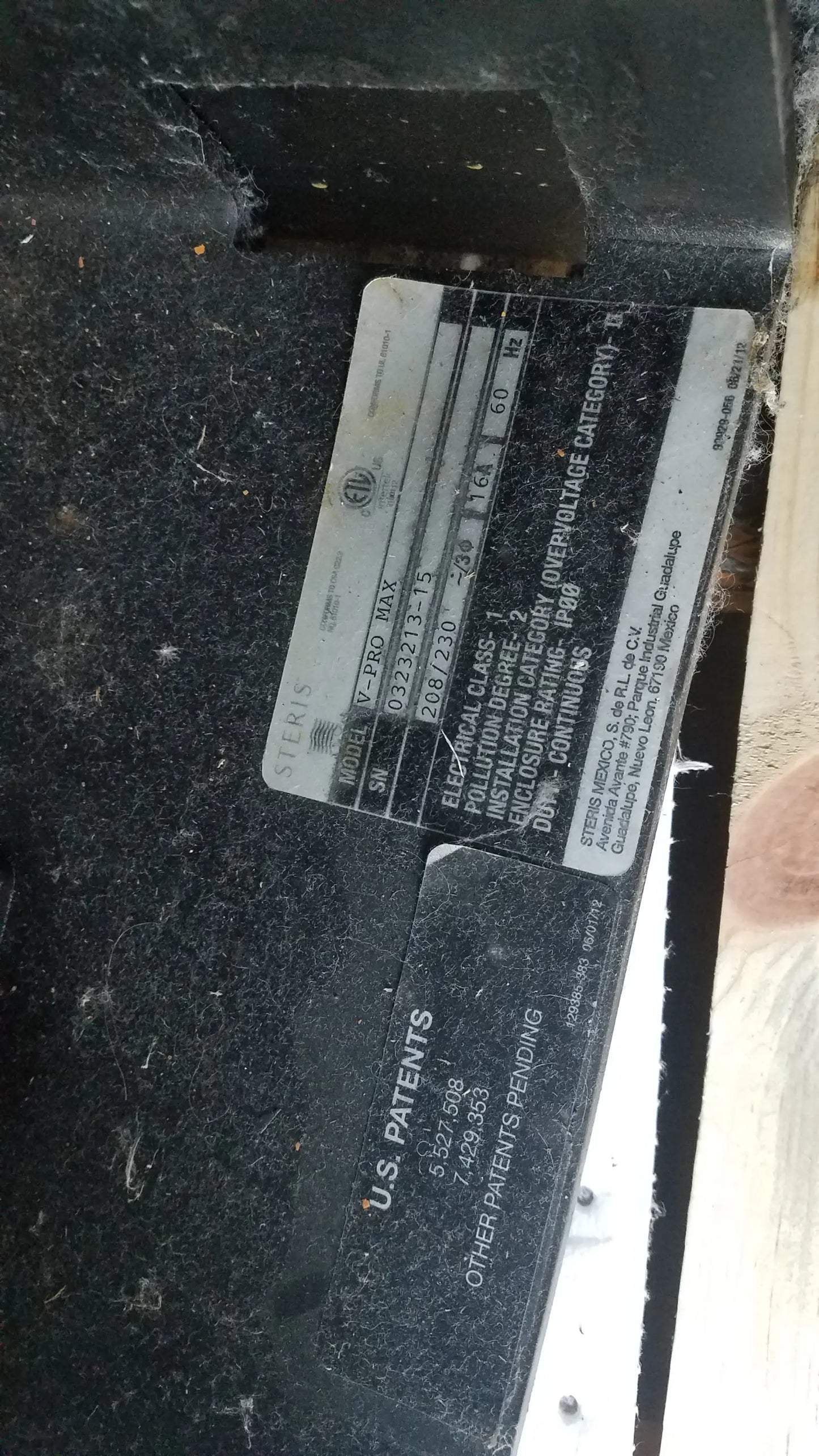 Black metal electrical panel label with white text and silver siemens logo on amsco steris v-pro max low temperature sterilization system