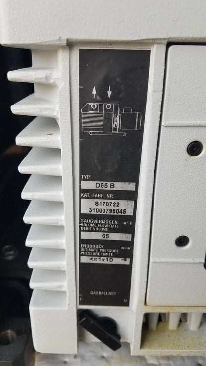 White plastic industrial vacuum pump with black label showing technical specs for amsco steris v-pro max low temperature sterilization system