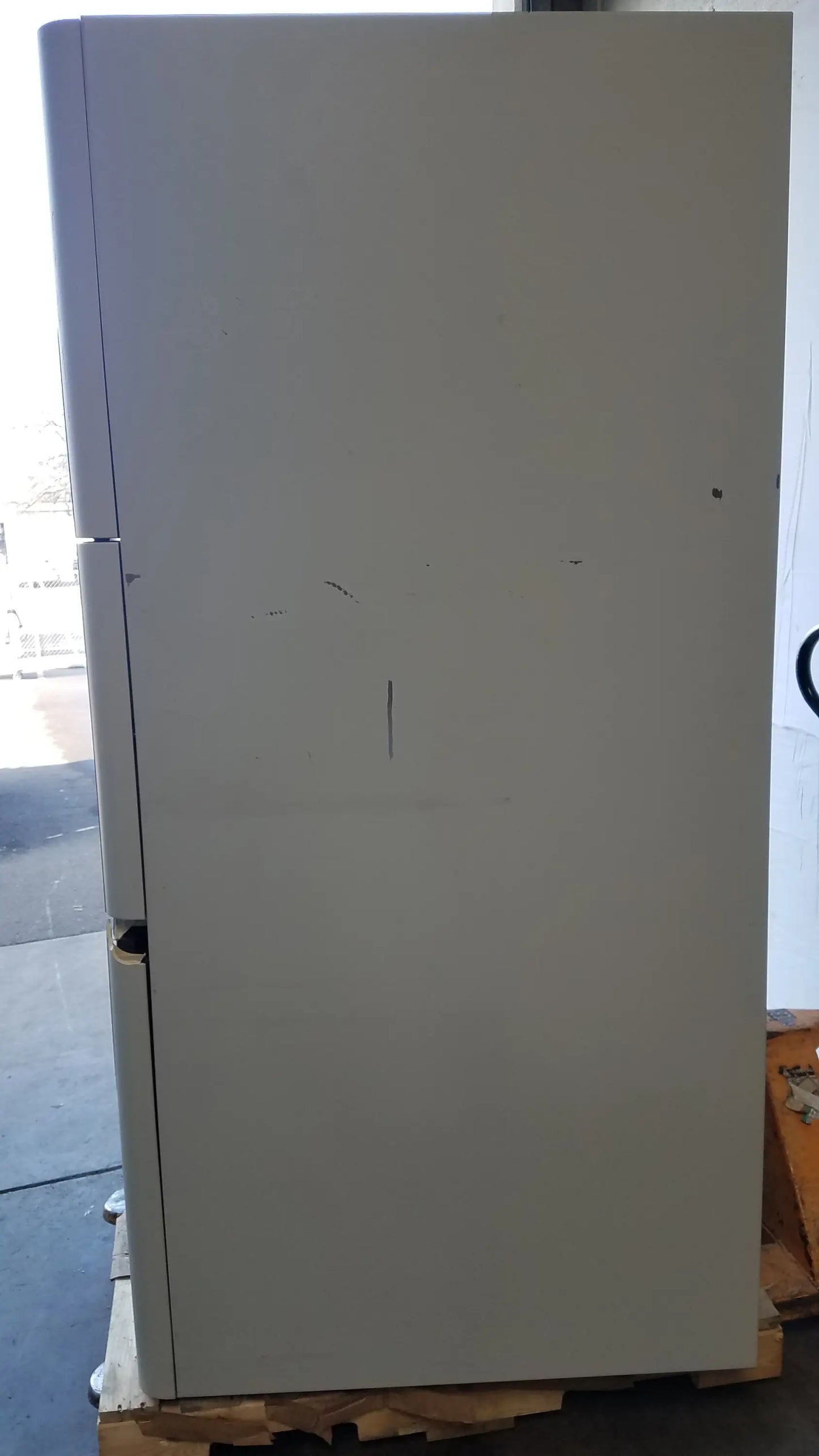 A tall white AMSCO Steris V-Pro Max low temperature sterilization system with smooth finish and minor surface scratches