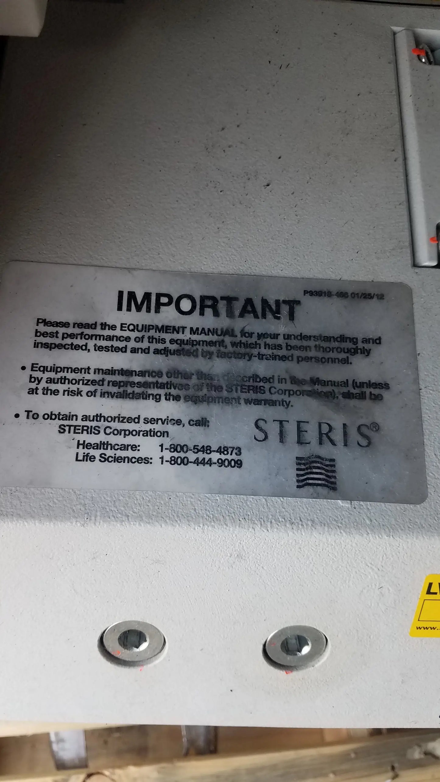 Silver metallic label with black text and steris logo on amsco steris v-pro max low temperature sterilization system back panel