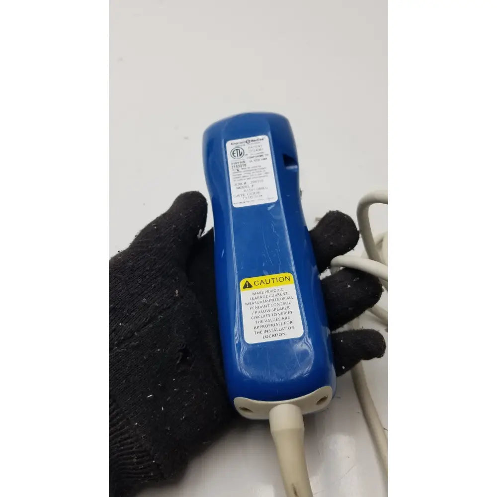 Blue plastic handheld electrical tester with white cable and warning labels for anacom medtek a1501-088dj pillow speaker remote