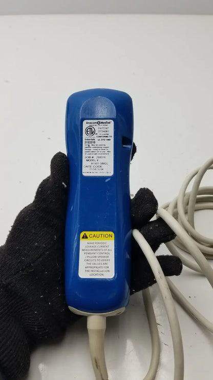 Blue plastic anacom medtek medtek hd supply a1501-088dj pillow speaker remote with white label and warning sticker visible