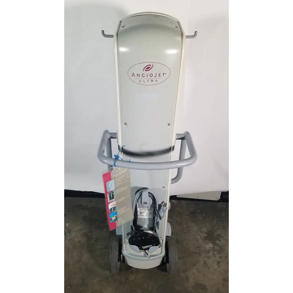 Gray metallic angiojet ultra thrombectomy system console 5000a mounted on wheeled cart with handlebars and storage compartments