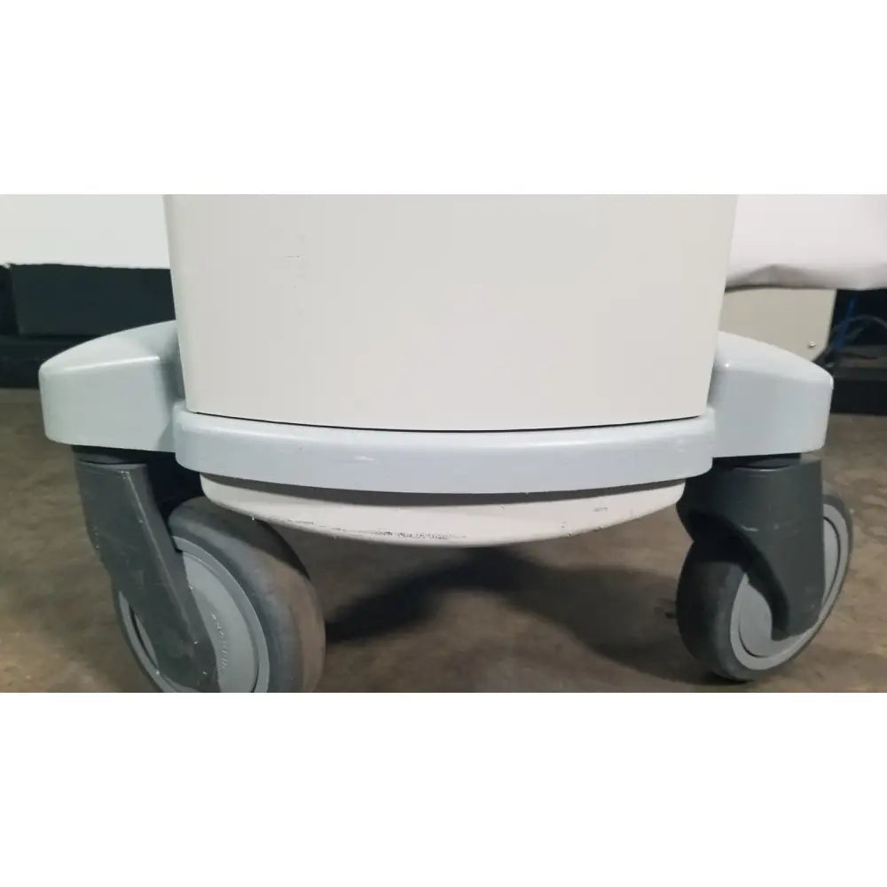 White angiojet ultra thrombectomy system console medical cart with gray casters and sturdy rounded base for reuse medical use