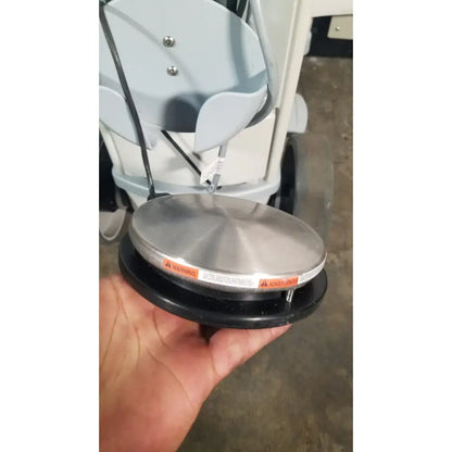 A sleek circular metallic sensor plate with brushed silver finish and black rubber base for angiojet ultra thrombectomy reuse medical system