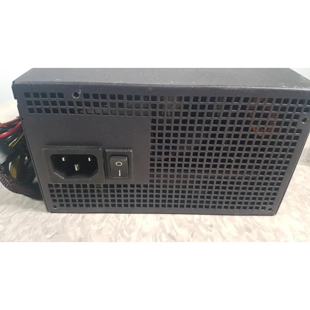 Black rectangular truepower 550w power supply with perforated metal casing ac input port and on/off switch backside view