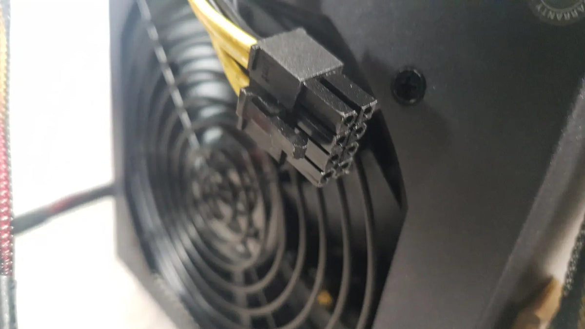 Black plastic 8-pin power connector with yellow cables on the back of the antec truepower 550w black switching power supply