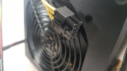 Black plastic 8-pin power connector with yellow cables on the back of the antec truepower 550w black switching power supply