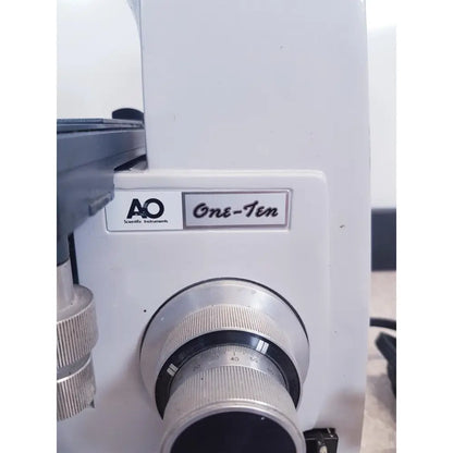White AO scientific instruments one-ten microscope with silver metallic lens ring and engraved focus scale illuminator model