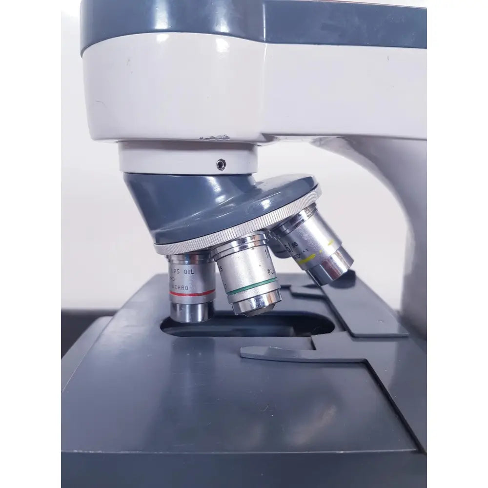 Gray and white scientific instruments one-ten compound microscope with multiple lenses including 25 oil illuminator model 1130A