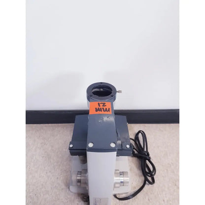 Gray and white scientific instruments one-ten illuminator model 1130A with black power cord and orange zmi label on body