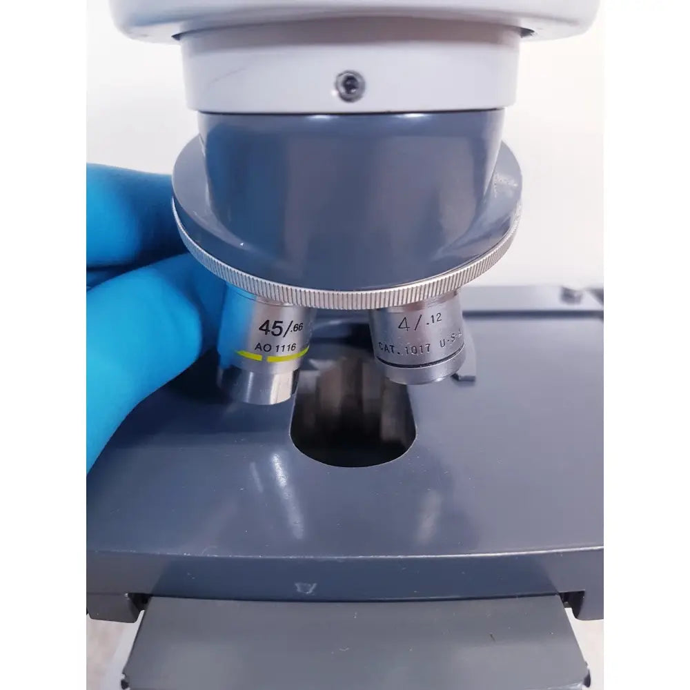 Gray microscope with silver objective lenses 45/60 and 4/.12 from ao scientific instruments one-ten illuminator model 1130a