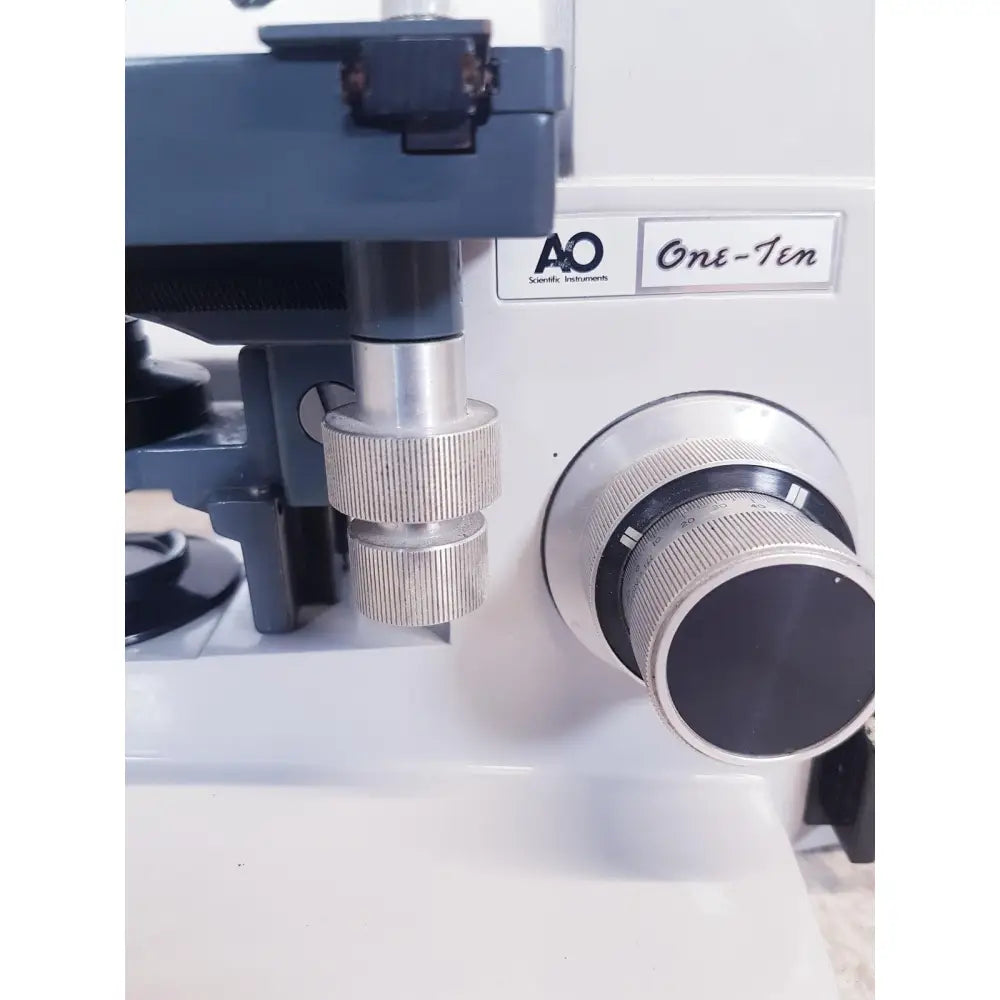 White ao scientific instruments one-ten illuminator model 1130a with silver metallic knobs and black accents in front view