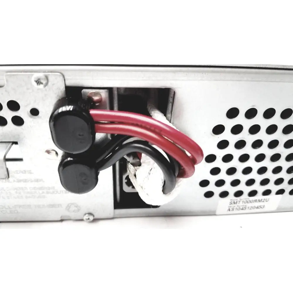 Black cylindrical power connectors with red and black wires on the back of the schneider electric smart-ups smt1000rm2u unit