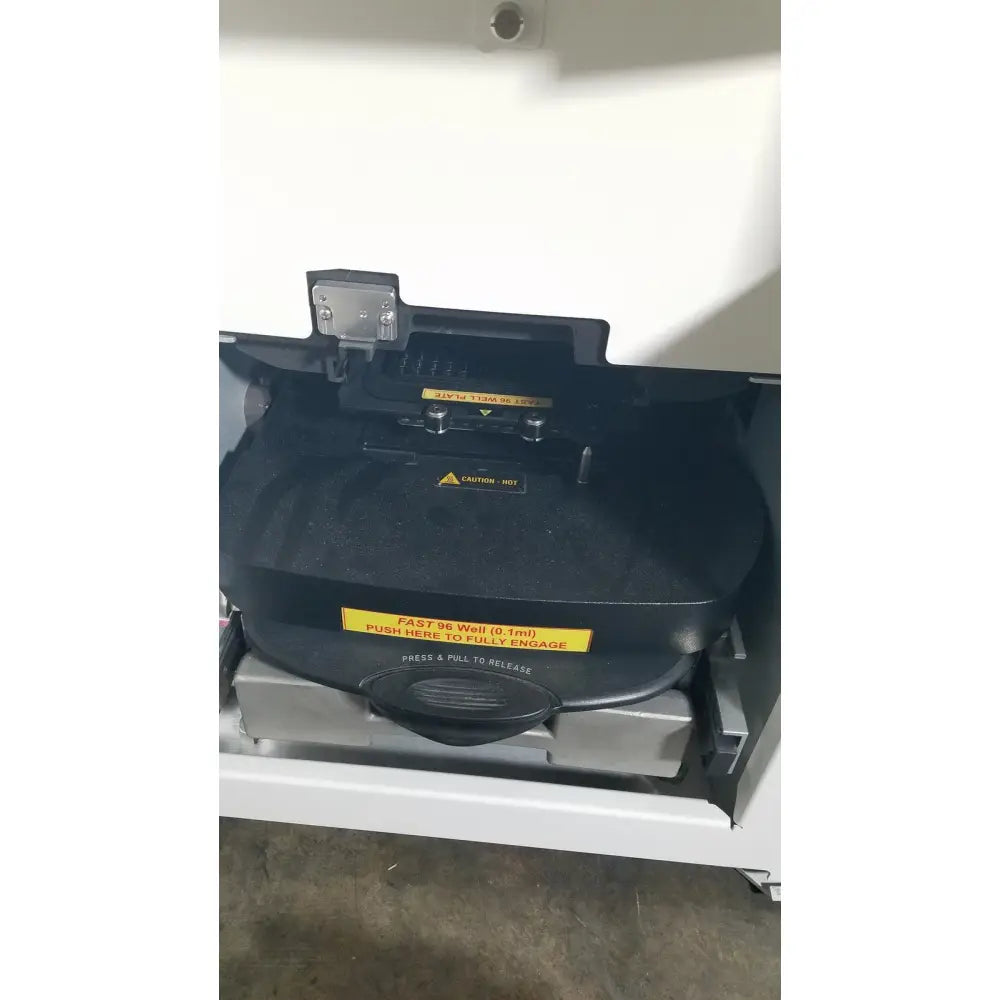 Black plastic well with yellow warning labels and handle for applied biosystems quantstudio dx real-time pcr instrument