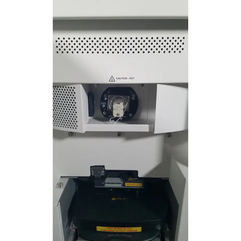 White applied biosystems quantstudio dx real-time pcr instrument with black components and caution-hot label