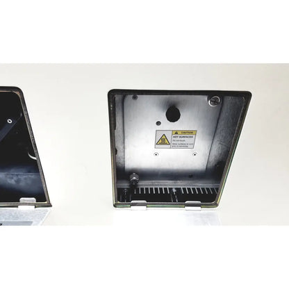 Applied Precision introduces a silver metallic industrial enclosure with warning label and ventilation slits for arrayWoRxe biochip reader