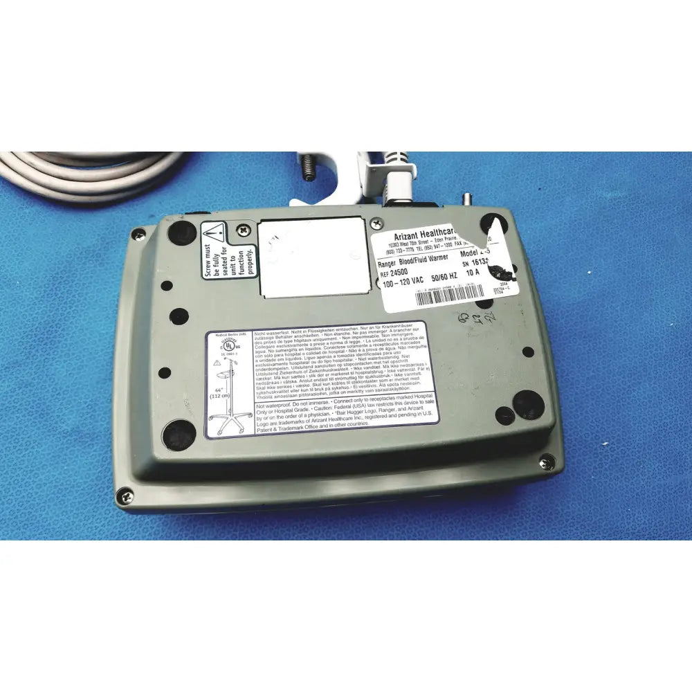Gray metal arizant healthcare ranger blood fluid warmer model 10-152 with coiled cable and white label stickers