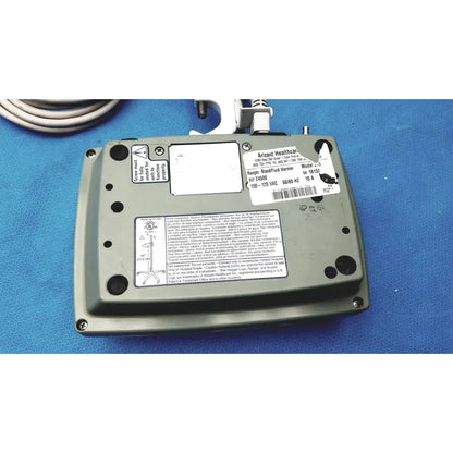 Gray metal arizant healthcare ranger blood fluid warmer model 10-152 with coiled cable and white label stickers