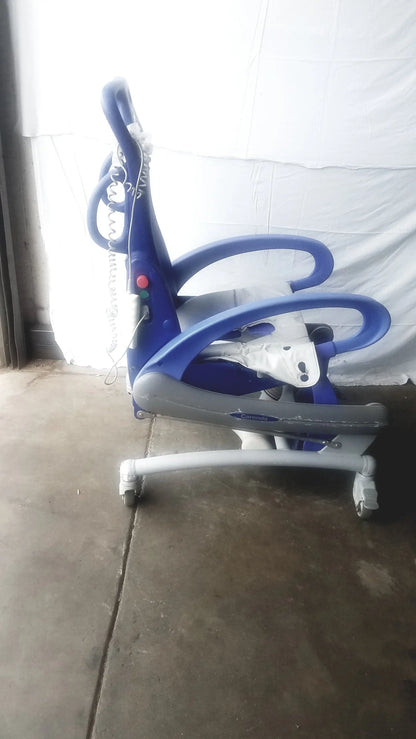 Blue and gray pediatric exercise bike with curved handlebars and wheels for arjo carendo multipurpose hygiene chair