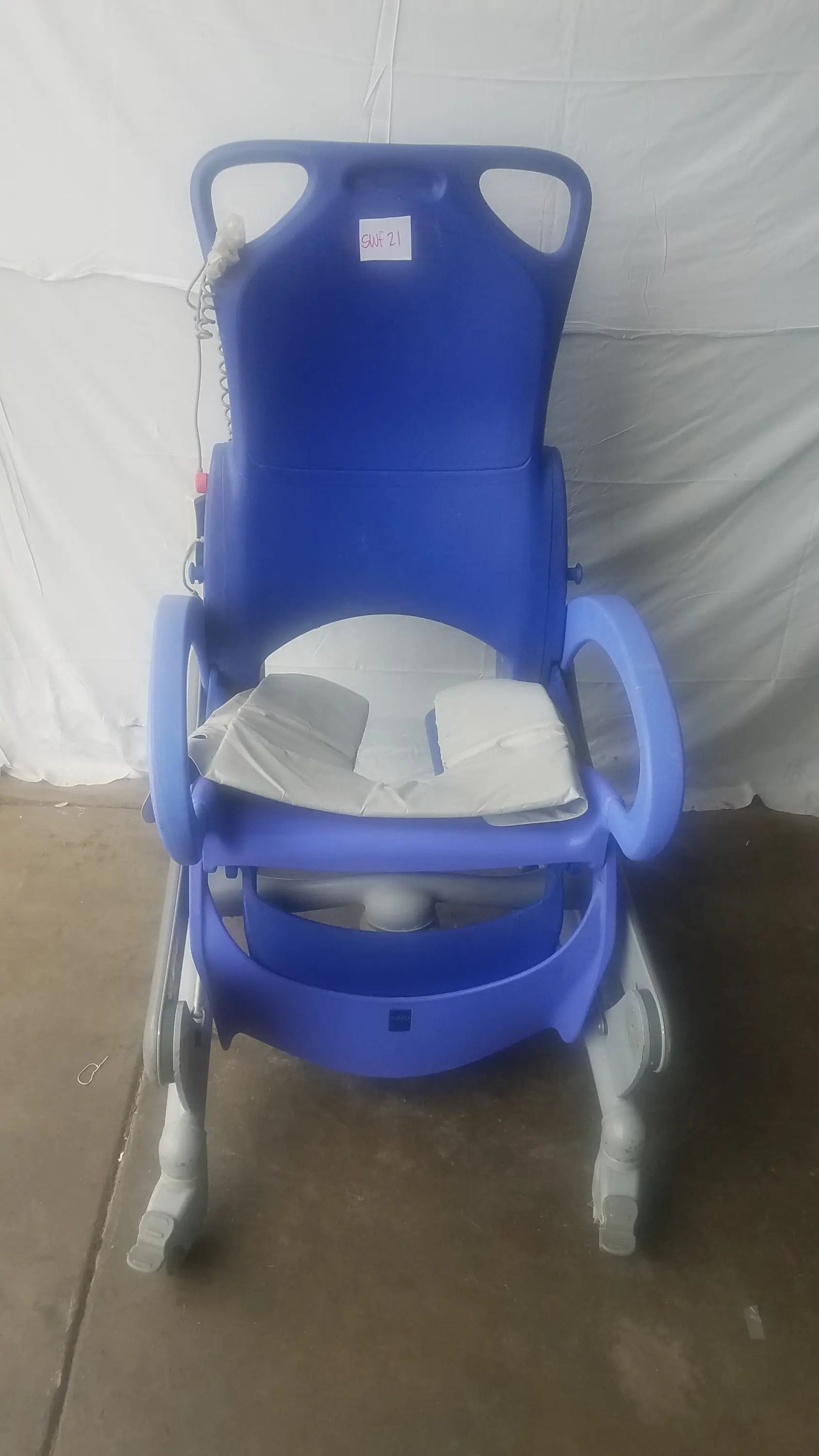 Blue plastic arjo carendo multipurpose hygiene chair with white cushioned seat and armrests for hospital use