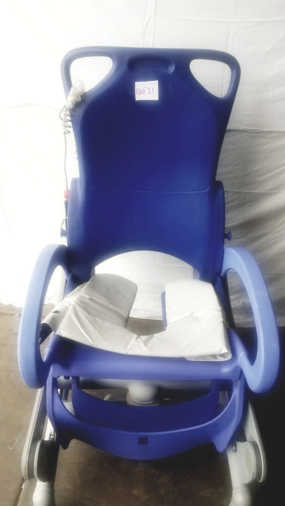 Blue plastic Arjo Carendo multipurpose hygiene chair with white cushion and padded armrests for hospital use