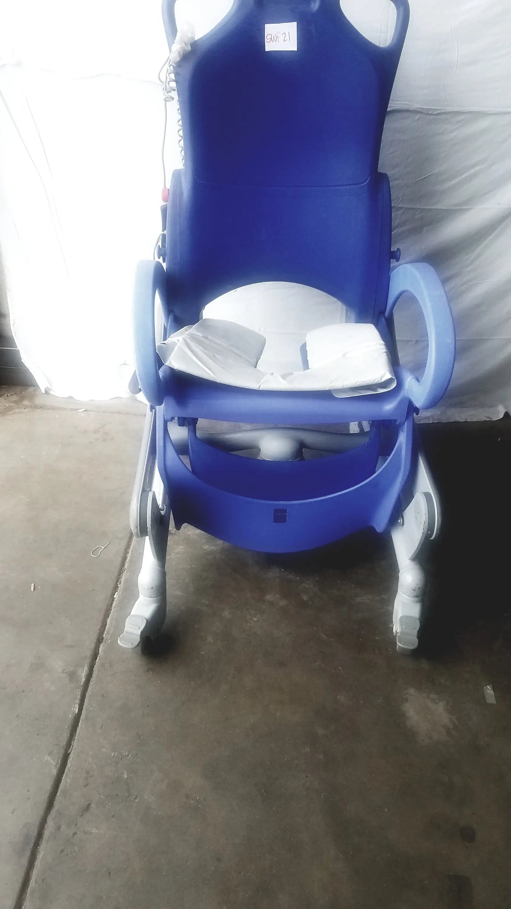 Blue plastic arjo carendo multipurpose hygiene chair with white cushion and wheels for enhanced mobility and hygiene