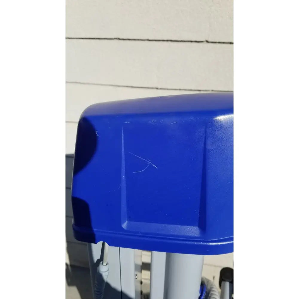 Blue plastic cover with glossy finish and minor scratches on arjo huntleigh power electric walker lift ambulatory support