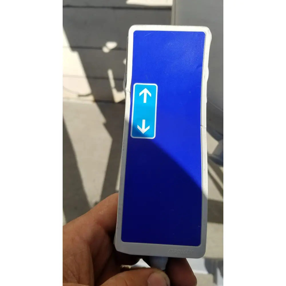 Blue rectangular arjo huntleigh power electric walker lift control with white border and arrow symbols held in hand
