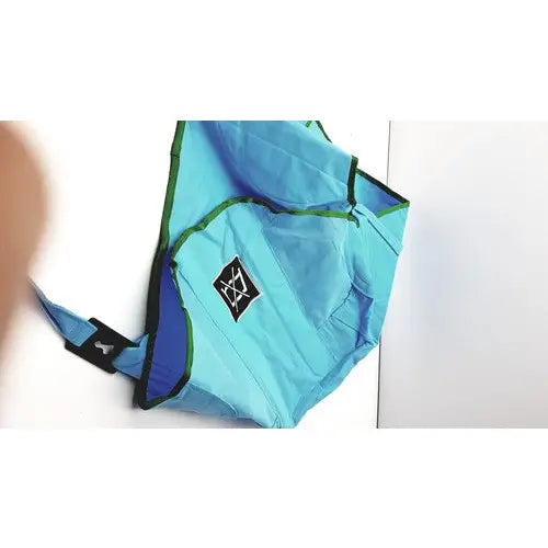 Light blue lightweight foldable camping chair with green trim and black logo patch, unrelated to arjo patient lift sling passive clip