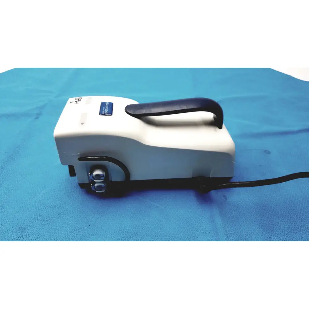 White medical device with black handle and knobs and blue label top arjohuntleigh flowtron excel dvt pump model 247001