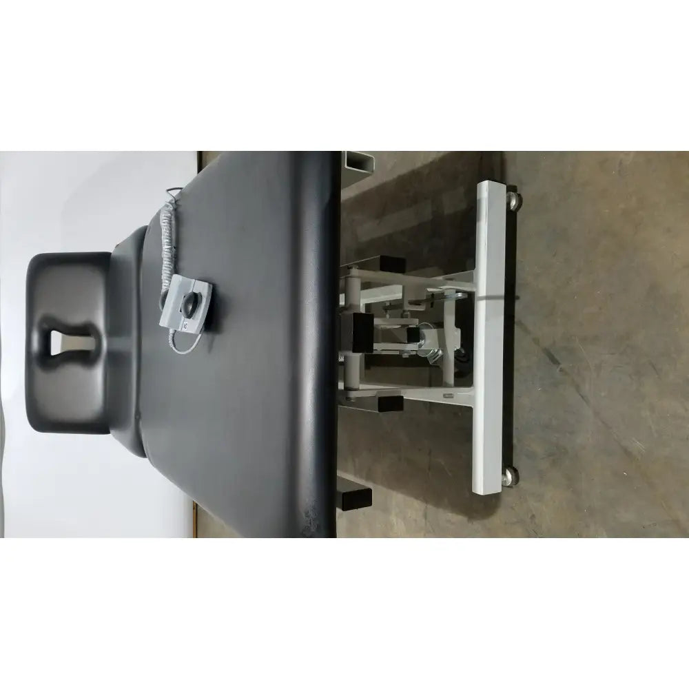 Armedica AM-300 black padded three section treatment table with silver metal frame and adjustable mechanical components