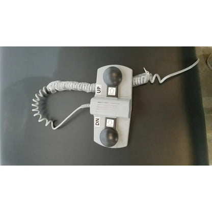 Gray plastic elevator call button panel with up and dn buttons on armedica am-300 three section treatment table