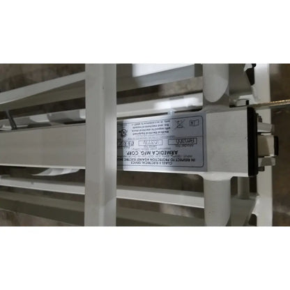 White label with black text on the back of an Armedica AM-300 three section treatment table electrical component