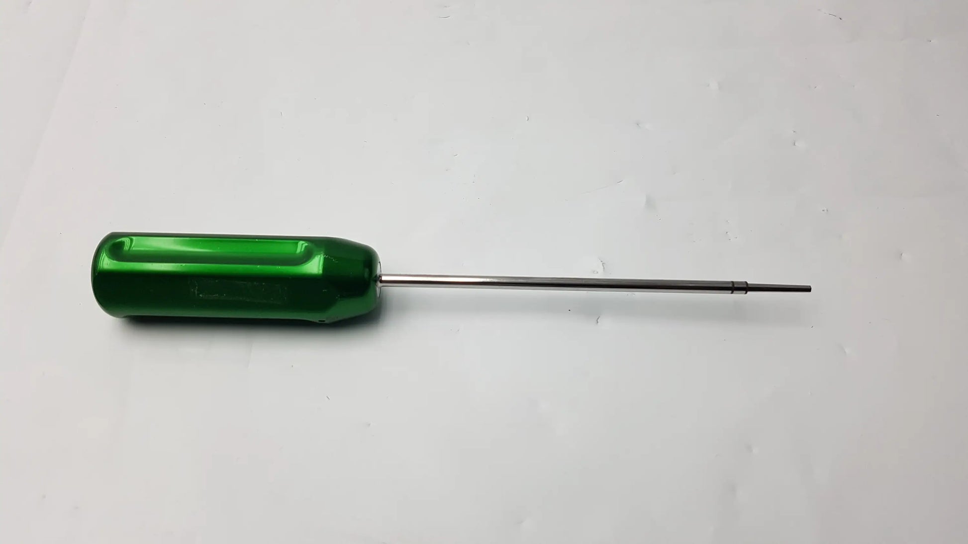Green metallic arthrex ar-1386 hex cannulated screwdriver with slender polished shaft and ergonomic handle