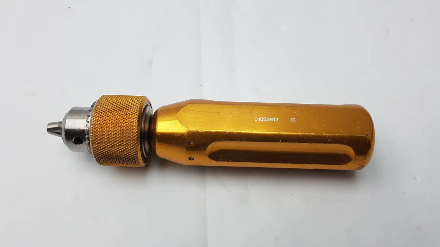 Gold-colored Arthrex AR-1415 surgical orthopedic tube driver extractor with textured grip and metallic chuck for precision use