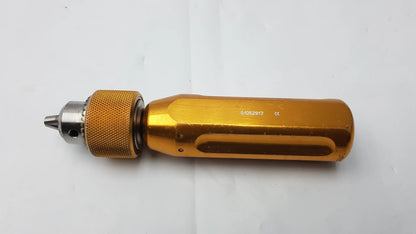 Gold-colored Arthrex AR-1415 surgical orthopedic tube driver extractor with textured grip and metallic chuck for precision use