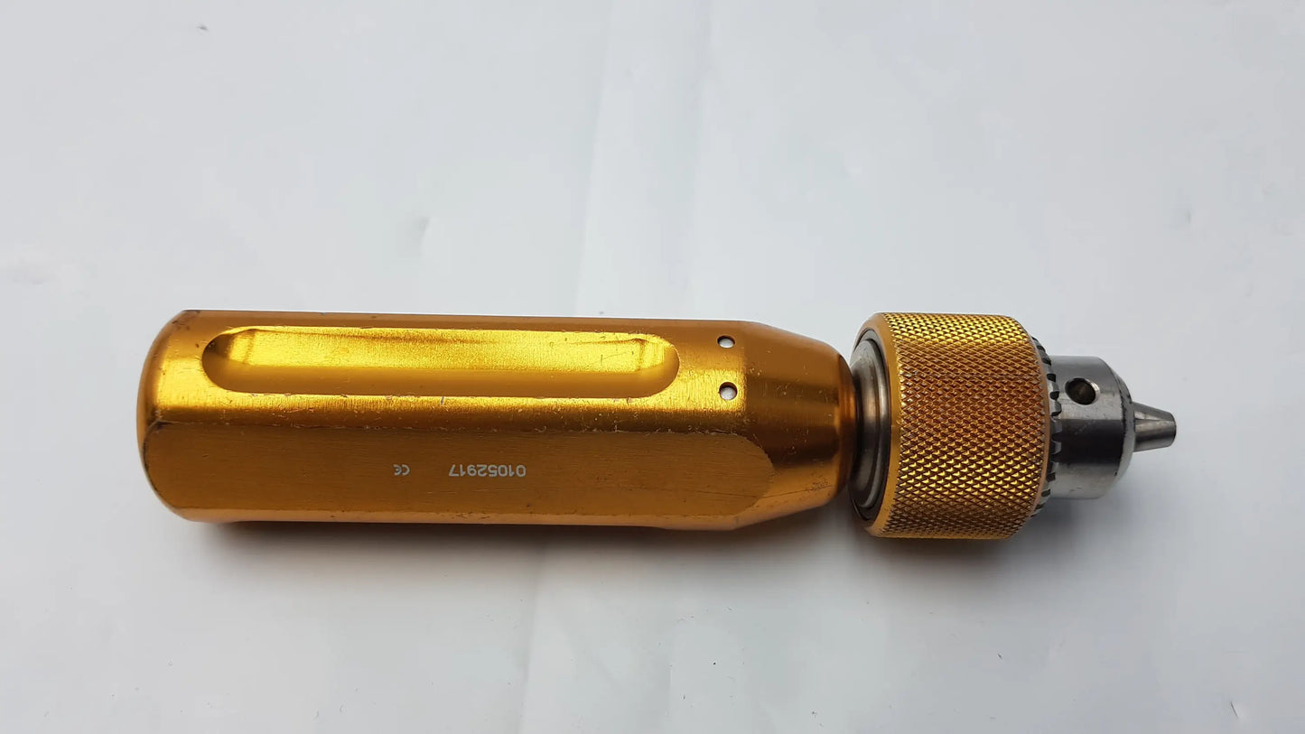Gold-colored metal Arthrex AR-1415 tube driver extractor with textured grip and engraved serial number visible