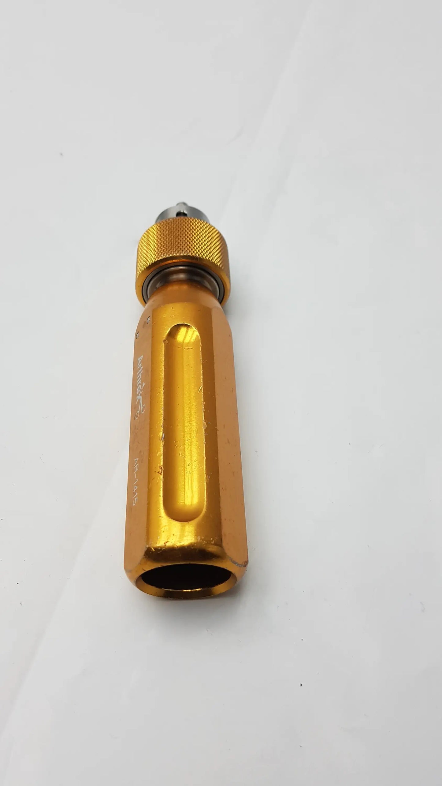 Gold-colored aluminum arthrex ar-1415 tube driver extractor with textured grip and engraved markings for orthopedic use
