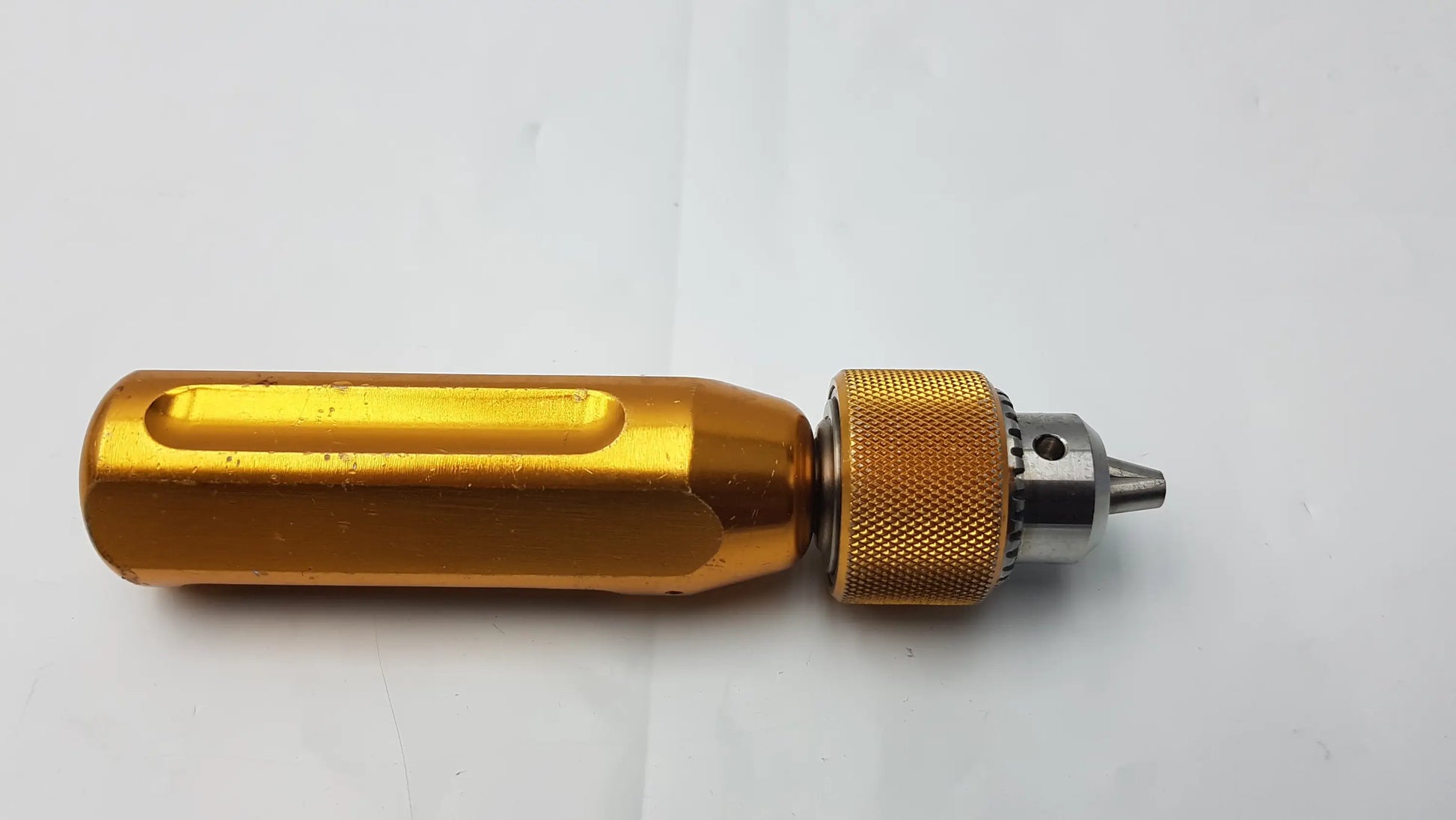 Gold-colored aluminum arthrex ar-1415 surgical orthopedic tube driver extractor with textured grip and metallic tip